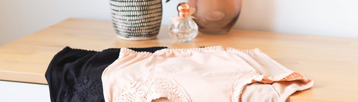 ladies underwear sitting on a dresser next to a plant