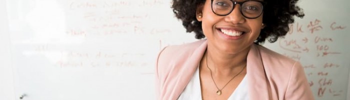lady smiling looking away from a whiteboard
