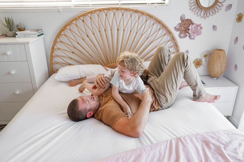 man and child on Conni fitted bed sheet